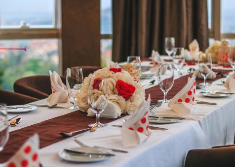 Elegant dining table with floral centerpiece and polka-dot napkins at a Kampala restaurant.